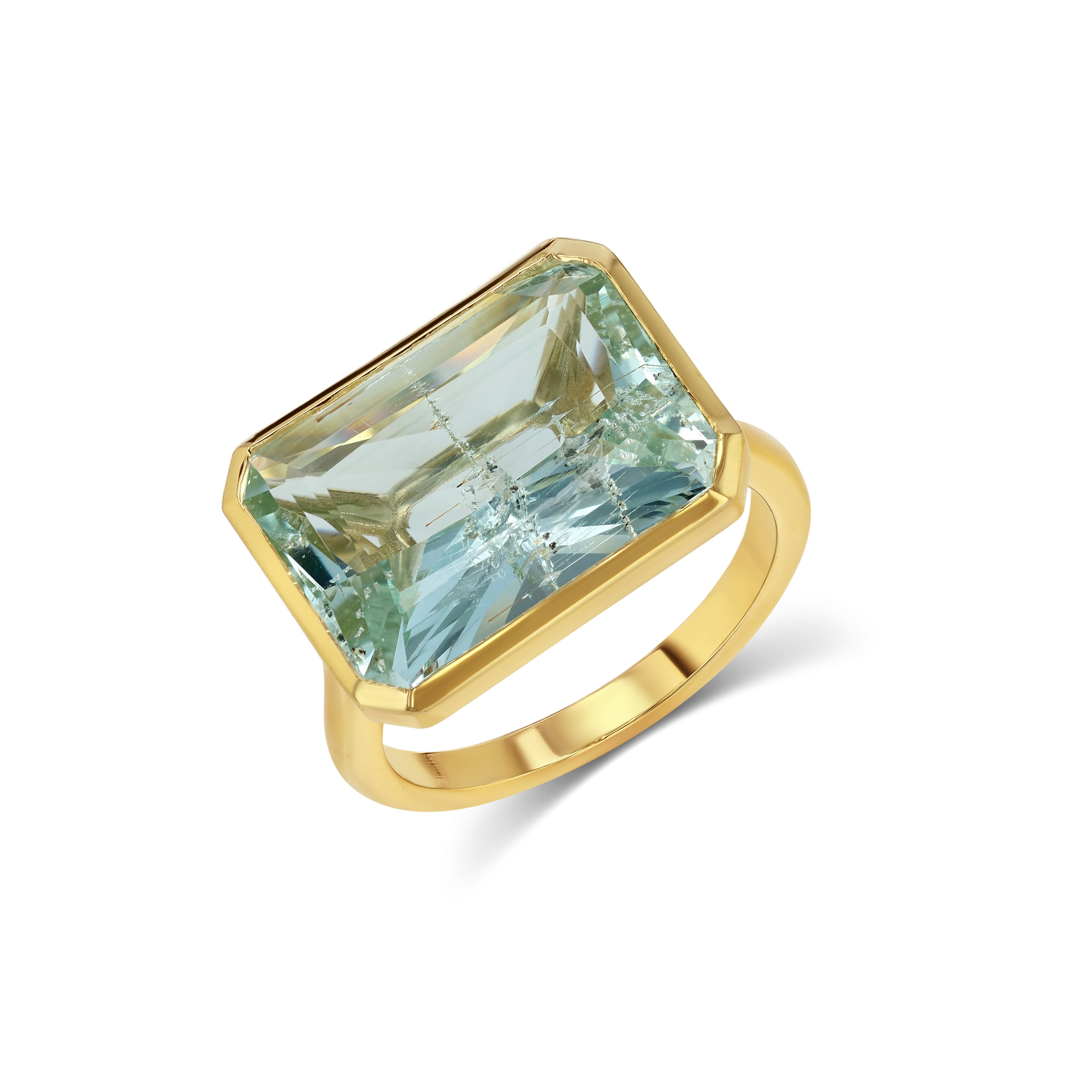 Gold ring with a large blue gemstone on a white background