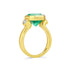 Gold ring with a green emerald gemstone in a floating setting on a white background
