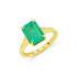 Gold prong set ring with a green emerald gemstone on a white background