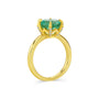 Gold ring with a green gemstone on a white background