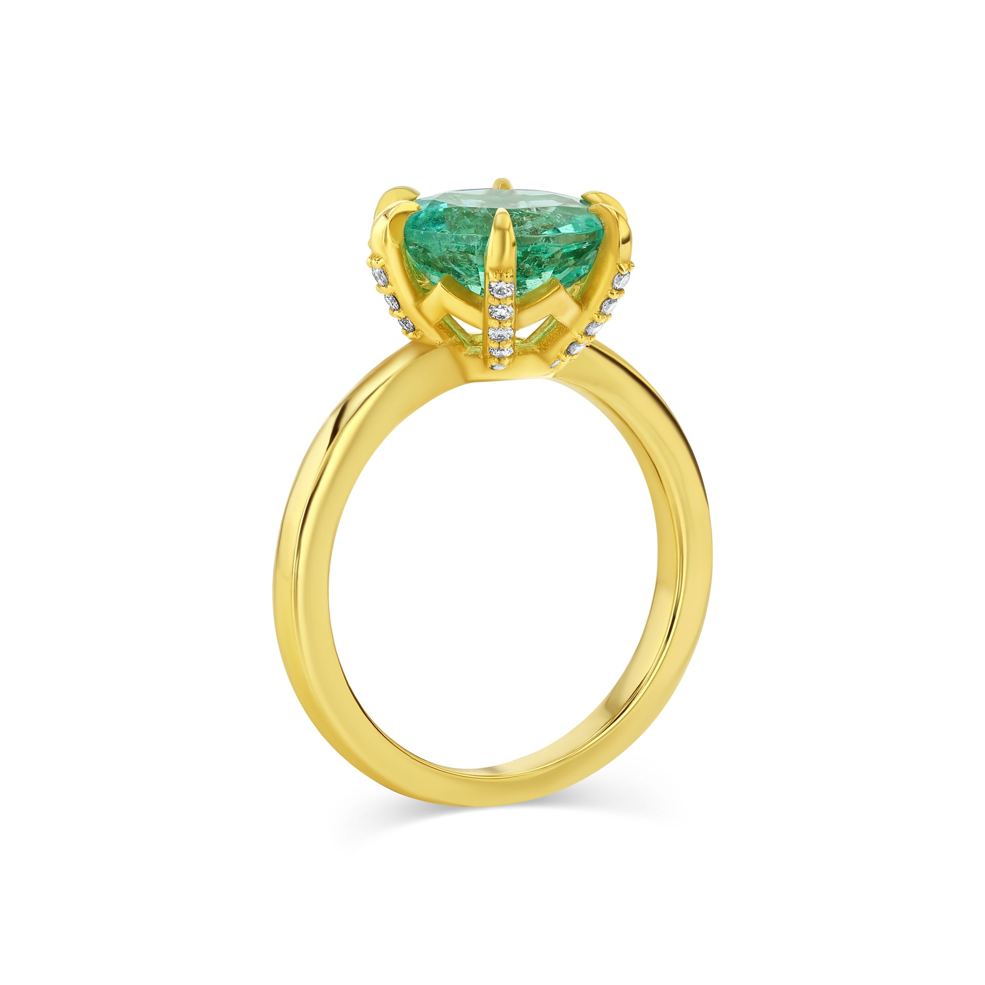 Gold ring with a green gemstone on a white background