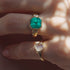 Close-up of two gold rings with gemstones on a blurred background