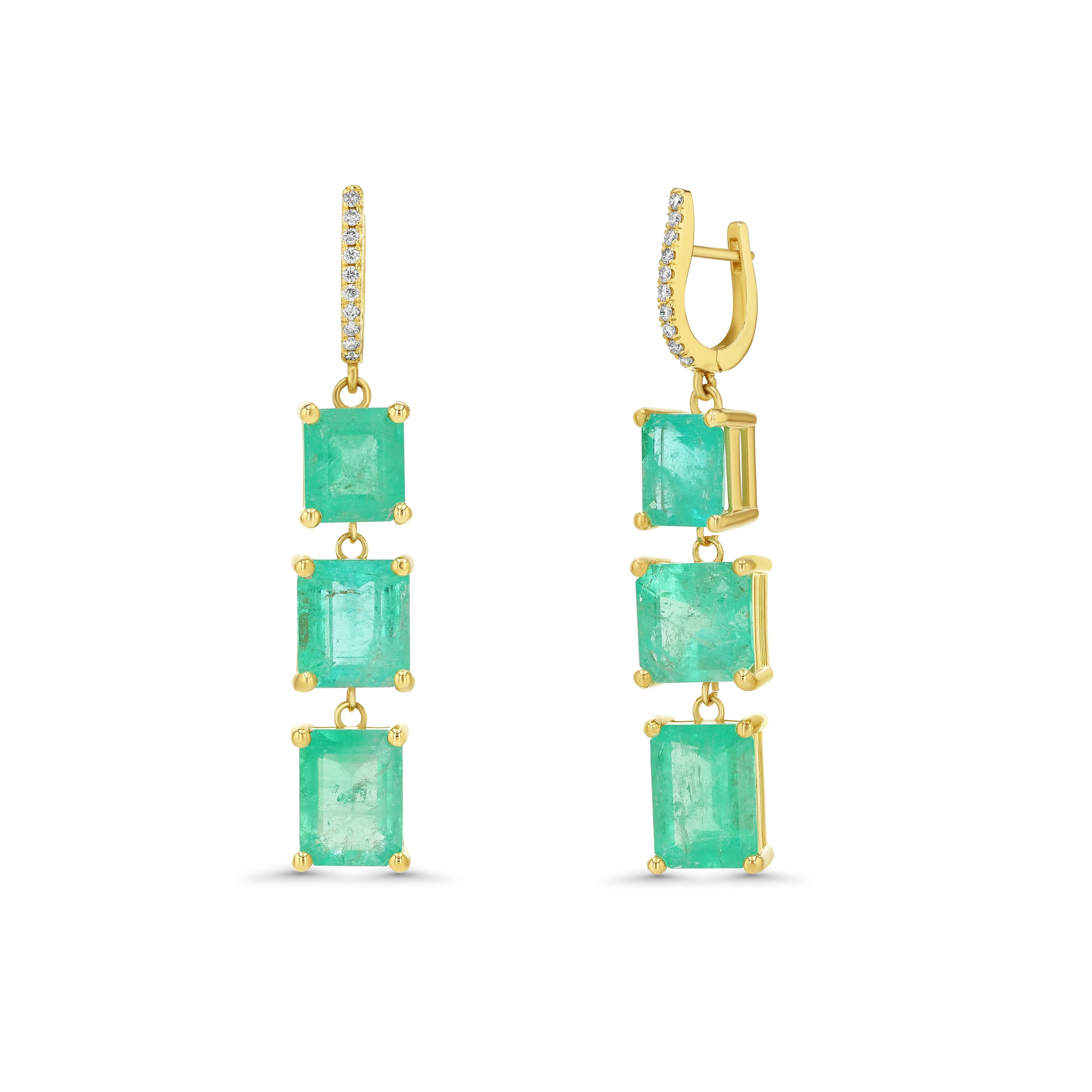 Gold earrings with emerald green gemstones on a white background
