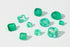 Collection of emerald gemstones on a white background