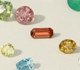 Collection of various colored gemstones on a light background