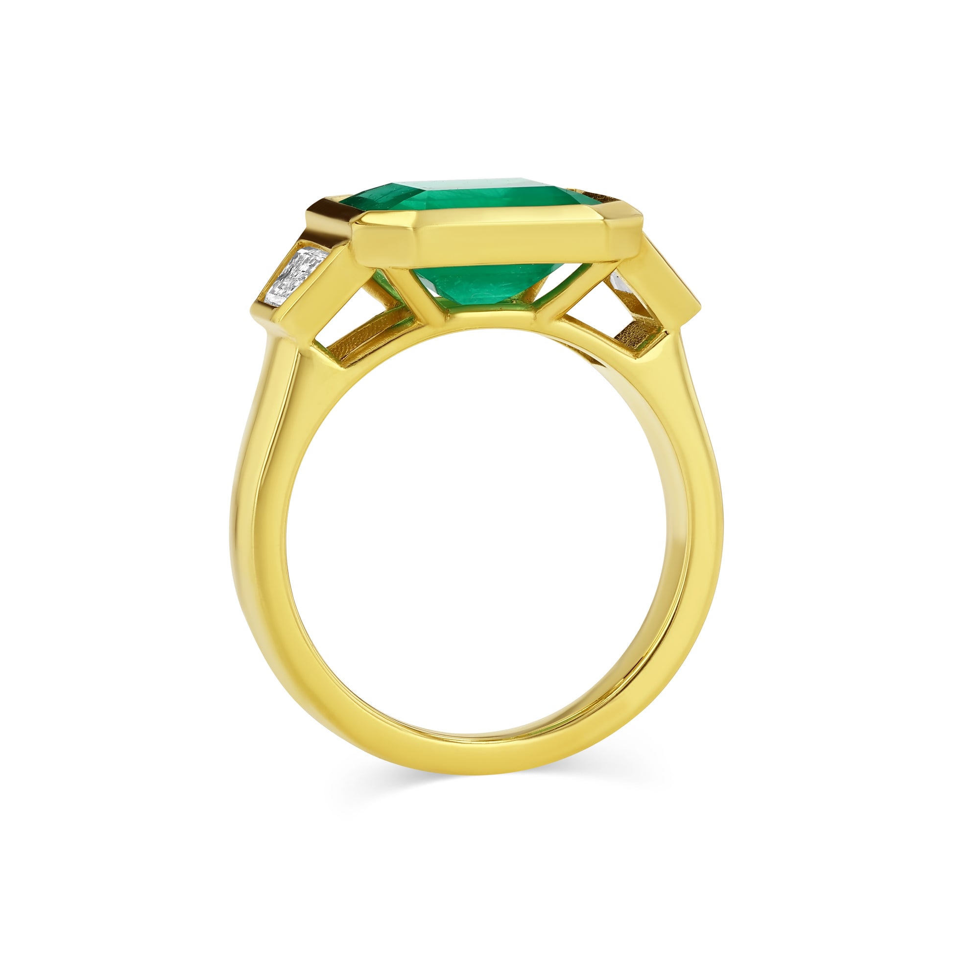 Gold ring with a green gemstone on a white background