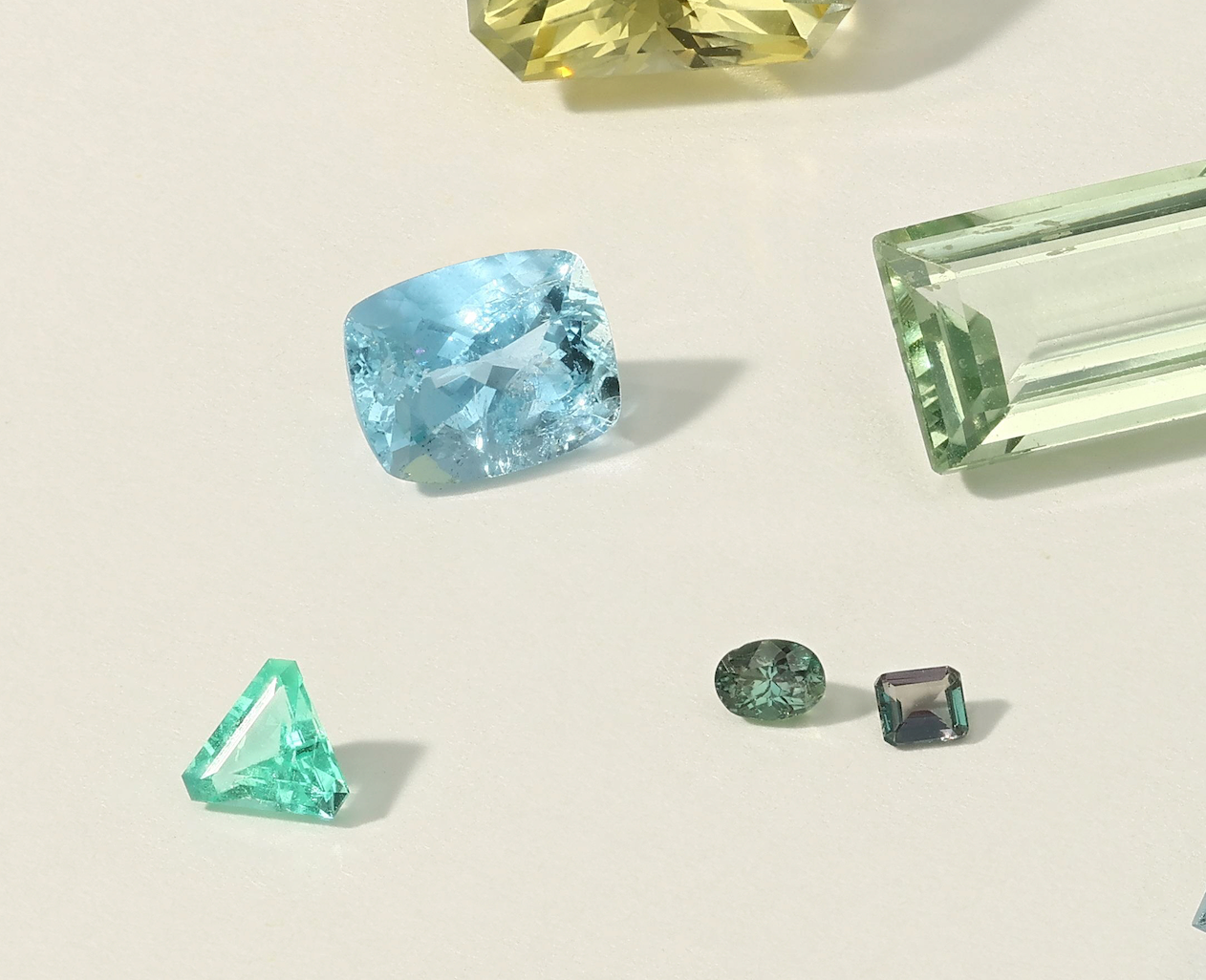 Collection of various gemstones on a light background