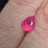 Pear-shaped pink gemstone on a person's skin